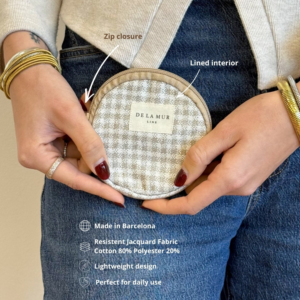 Model holding the DE LA MUR gingham coin purse, features and fabric infographic