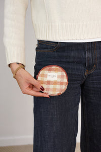 Model holding the DE LA MUR gingham round coin purse at the jeans pocket, lifestyle shot
