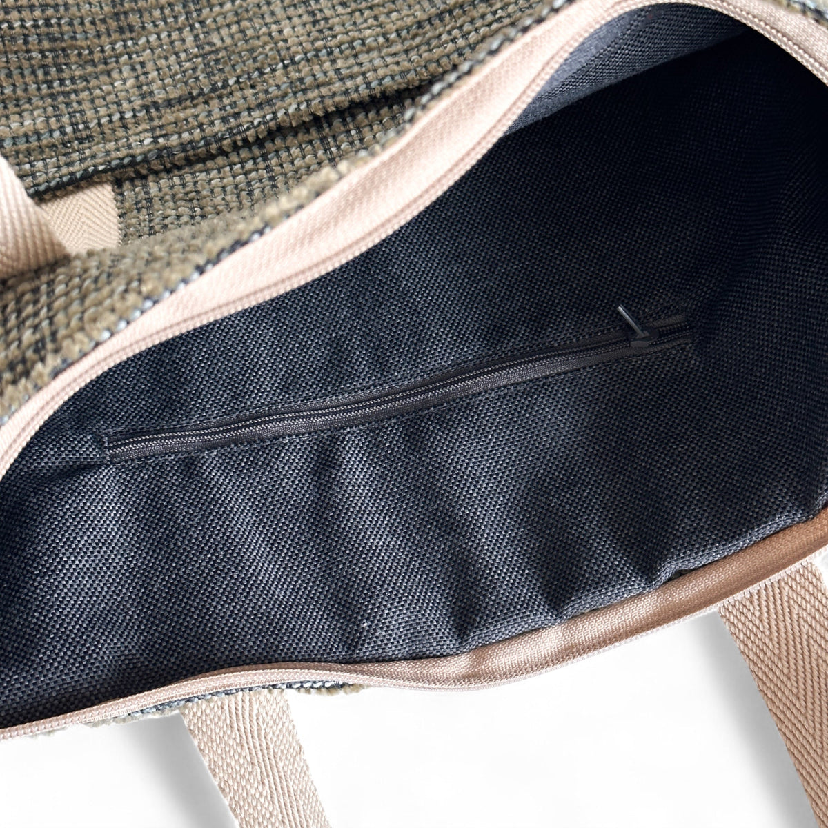 Open DE LA MUR khaki green backpack showing the lined interior zip pocket