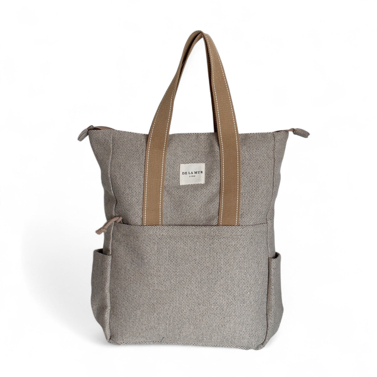 DE LA MUR Sydney herringbone backpack in beige with front pocket, front view