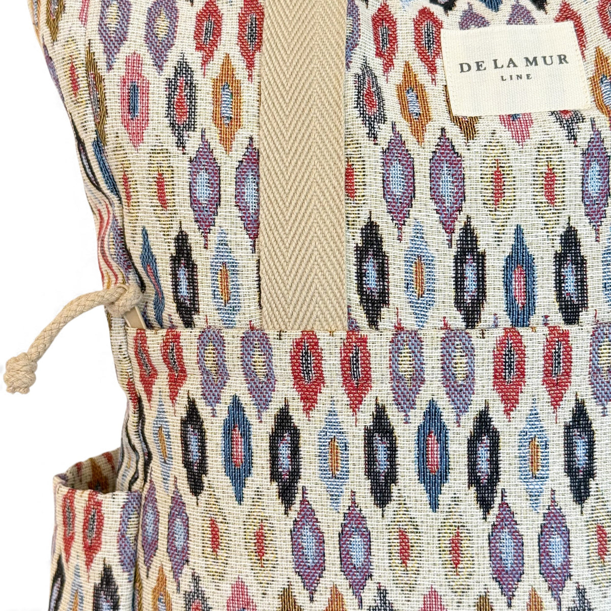 Close-up of the DE LA MUR Line label and ikat jacquard fabric