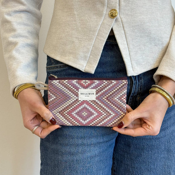 Model with the DE LA MUR Geometric Jacquard Small Makeup Bag / Coin Purse – Pink & Lilac (Nana)
