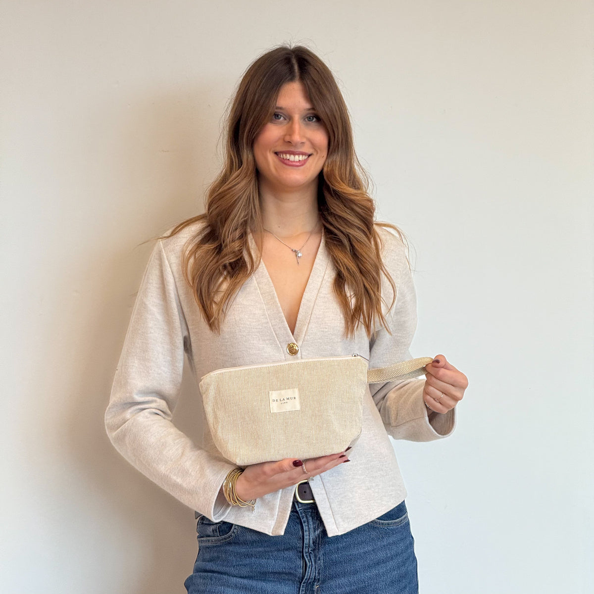 Model with the DE LA MUR Striped Jacquard Large Makeup Bag – Olive & Cream (Foz)