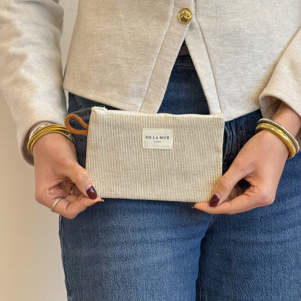 Model with the DE LA MUR Striped Jacquard Small Makeup Bag / Coin Purse – Olive & Cream (Foz)