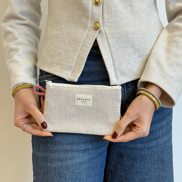 Model with the DE LA MUR Striped Small Makeup Bag / Coin Purse – Gray & Cream (Ibi)