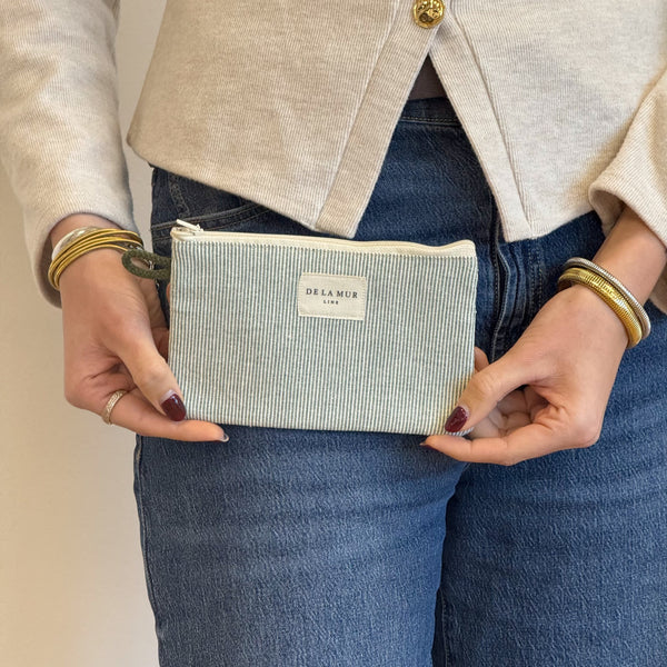Model with the DE LA MUR Striped Small Makeup Bag / Coin Purse – Light Green & Green (Teo)