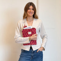 Model with the DE LA MUR Zigzag Jacquard Book Cover With Matching Bookmark – Pink & Orange (Fuego)
