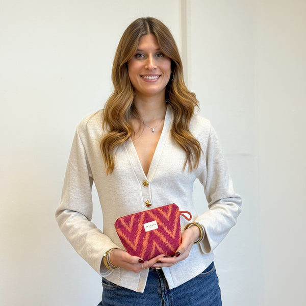 Model with the DE LA MUR Zigzag Jacquard Small Makeup Bag – Pink & Orange (Fuego)