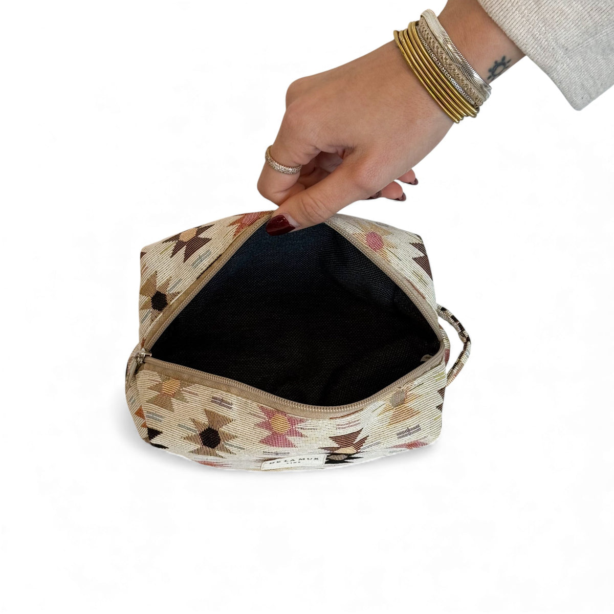 Open DE LA MUR Royal makeup bag showing the dark lined interior
