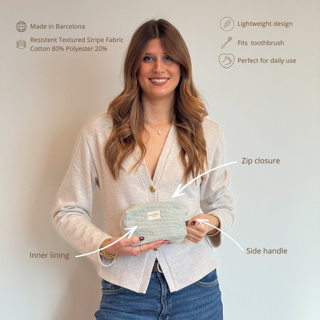 Model holding the DE LA MUR Teo makeup bag with feature callouts and details