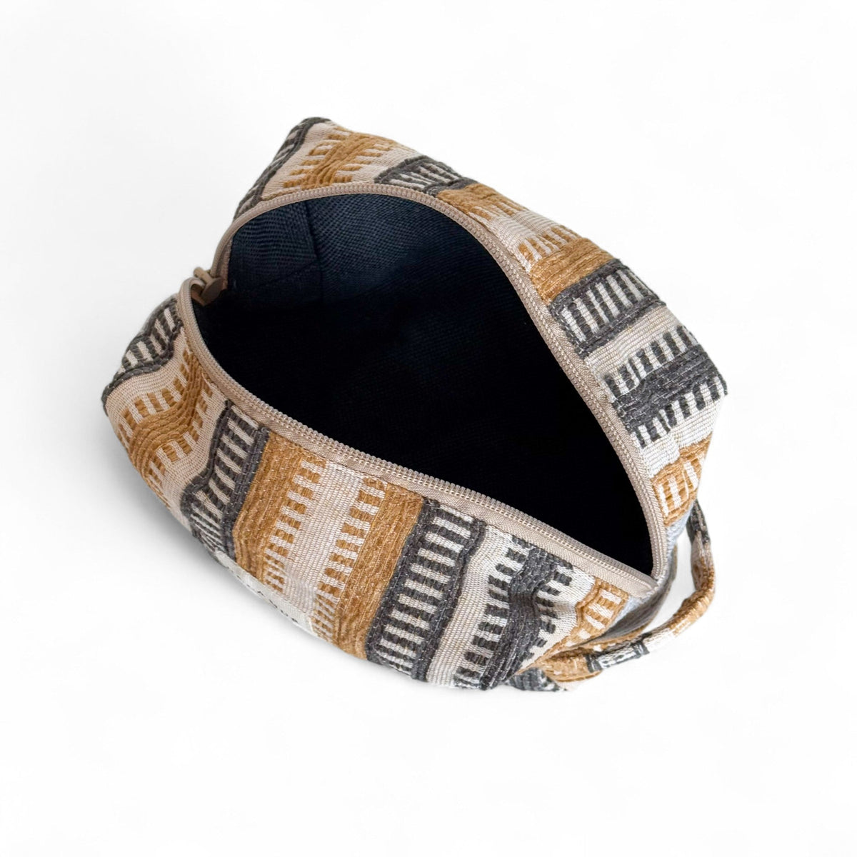Open DE LA MUR Tron jacquard makeup bag showing the black lined interior