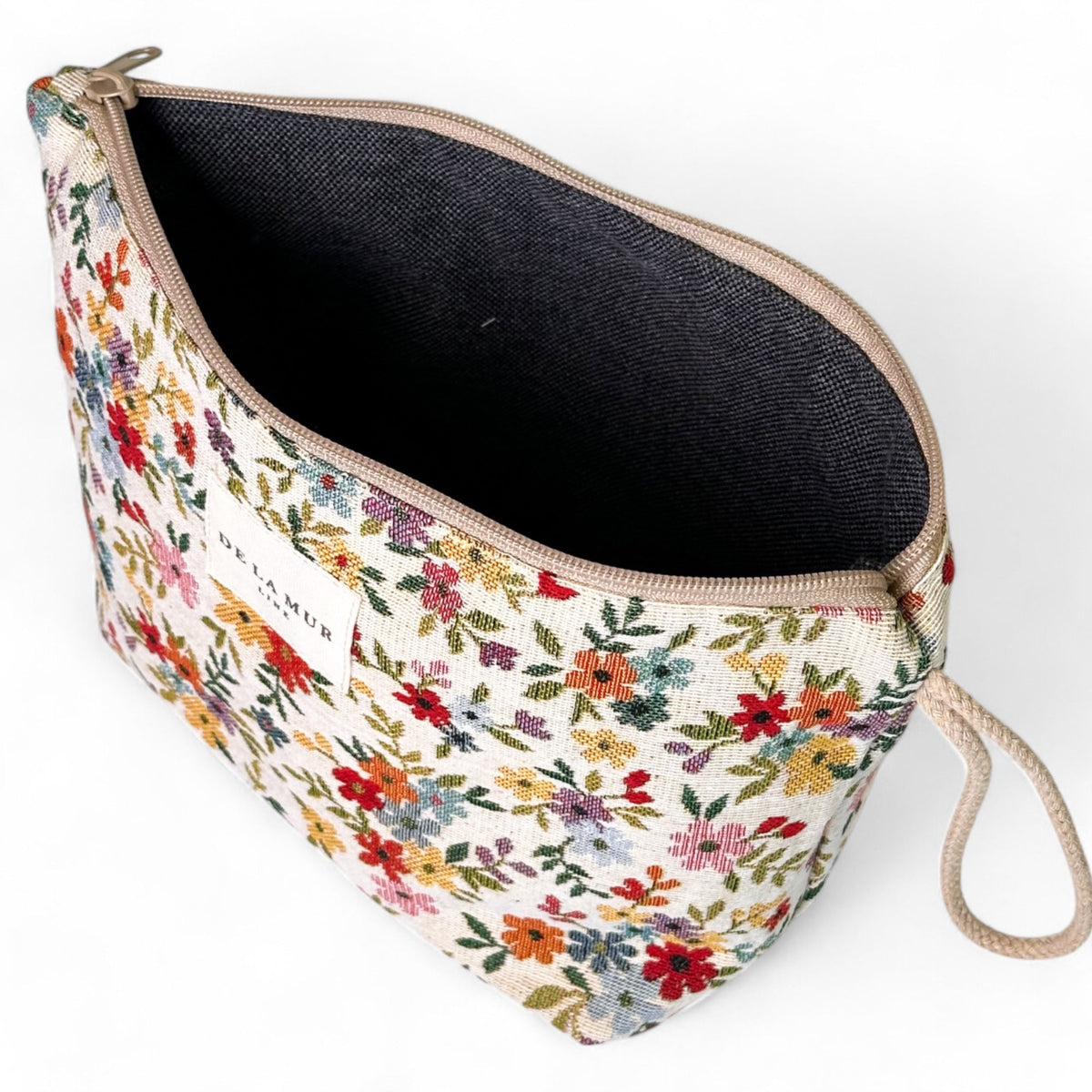Open DE LA MUR floral jacquard large makeup bag showing dark lined interior