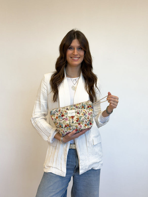 Model holding the DE LA MUR floral jacquard large makeup bag by its strap