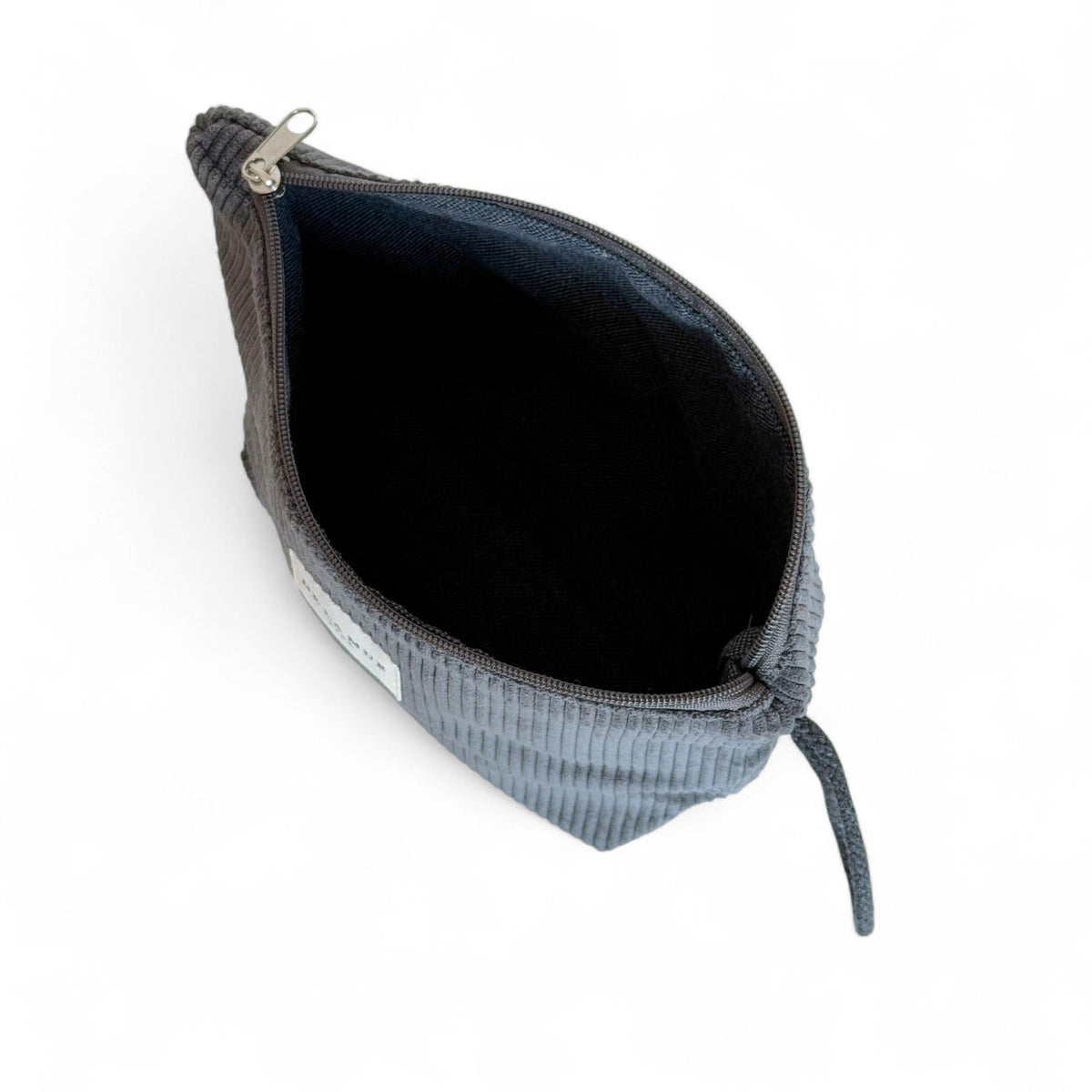 Open DE LA MUR Boni corduroy makeup bag showing black lined interior