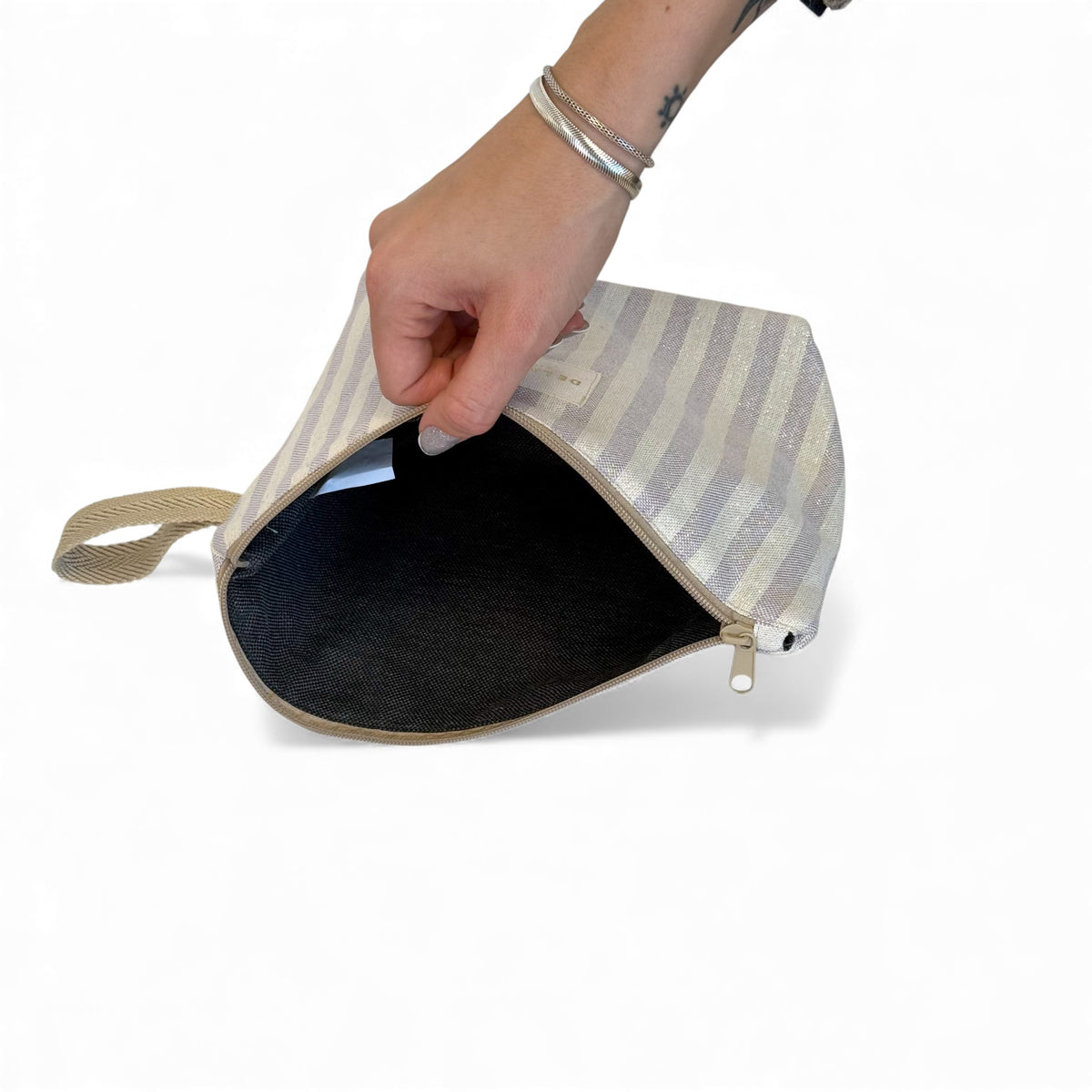 Open DE LA MUR Lulil makeup bag showing the black lined interior
