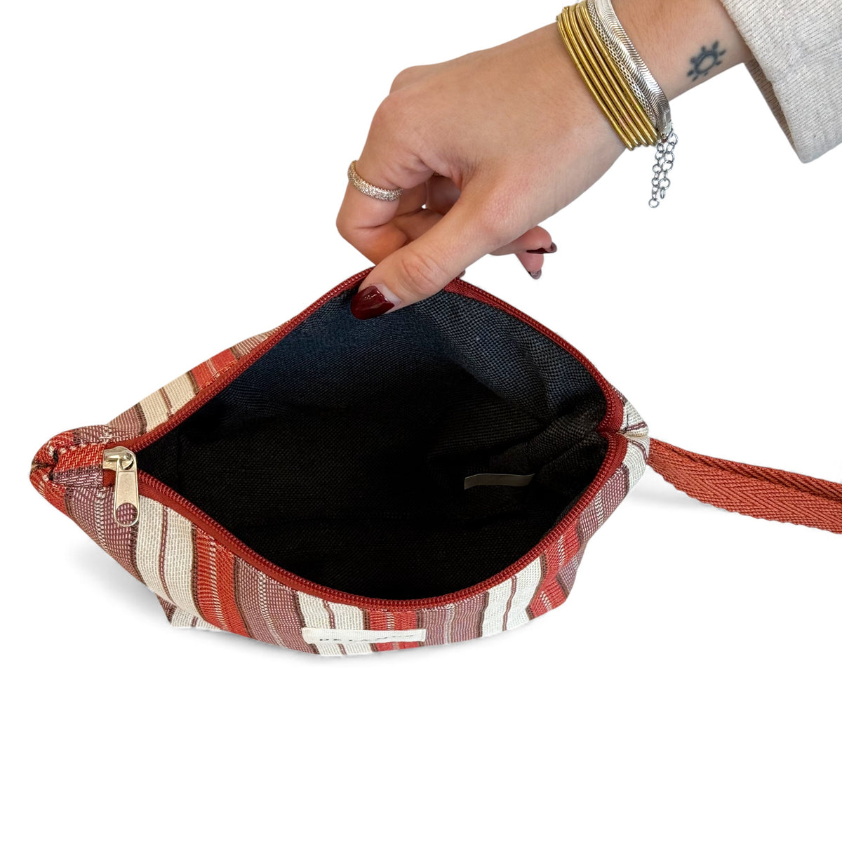 Open DE LA MUR Make striped jacquard makeup bag showing black lined interior