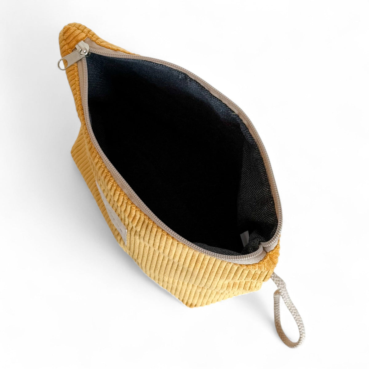 Open DE LA MUR Taz corduroy makeup bag showing dark lined interior