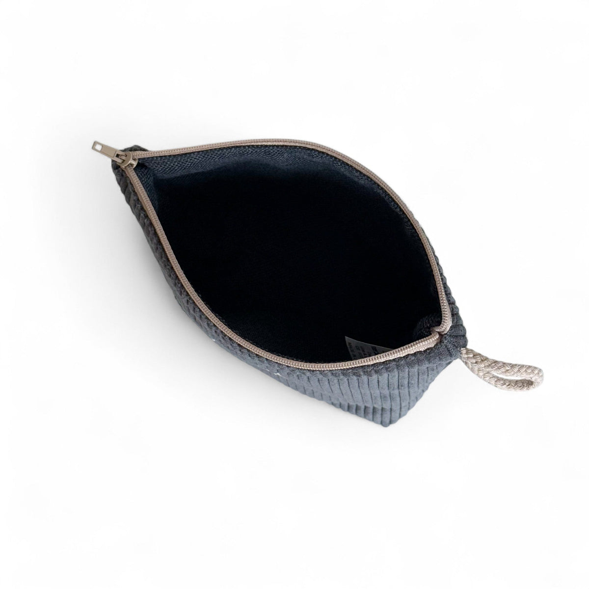 Open gray Boni makeup bag showing the dark lined interior