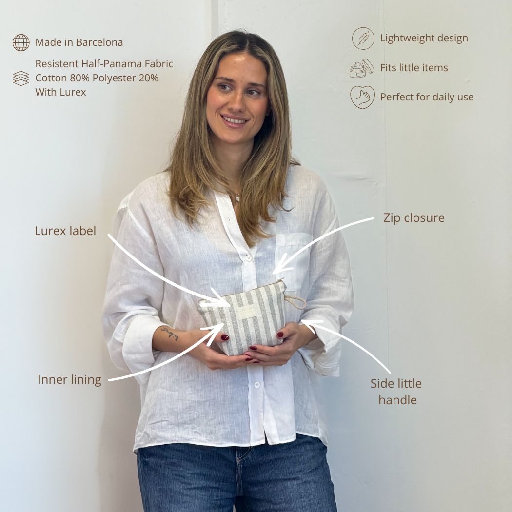Model holding the DE LA MUR striped makeup bag with labeled features and fabric details