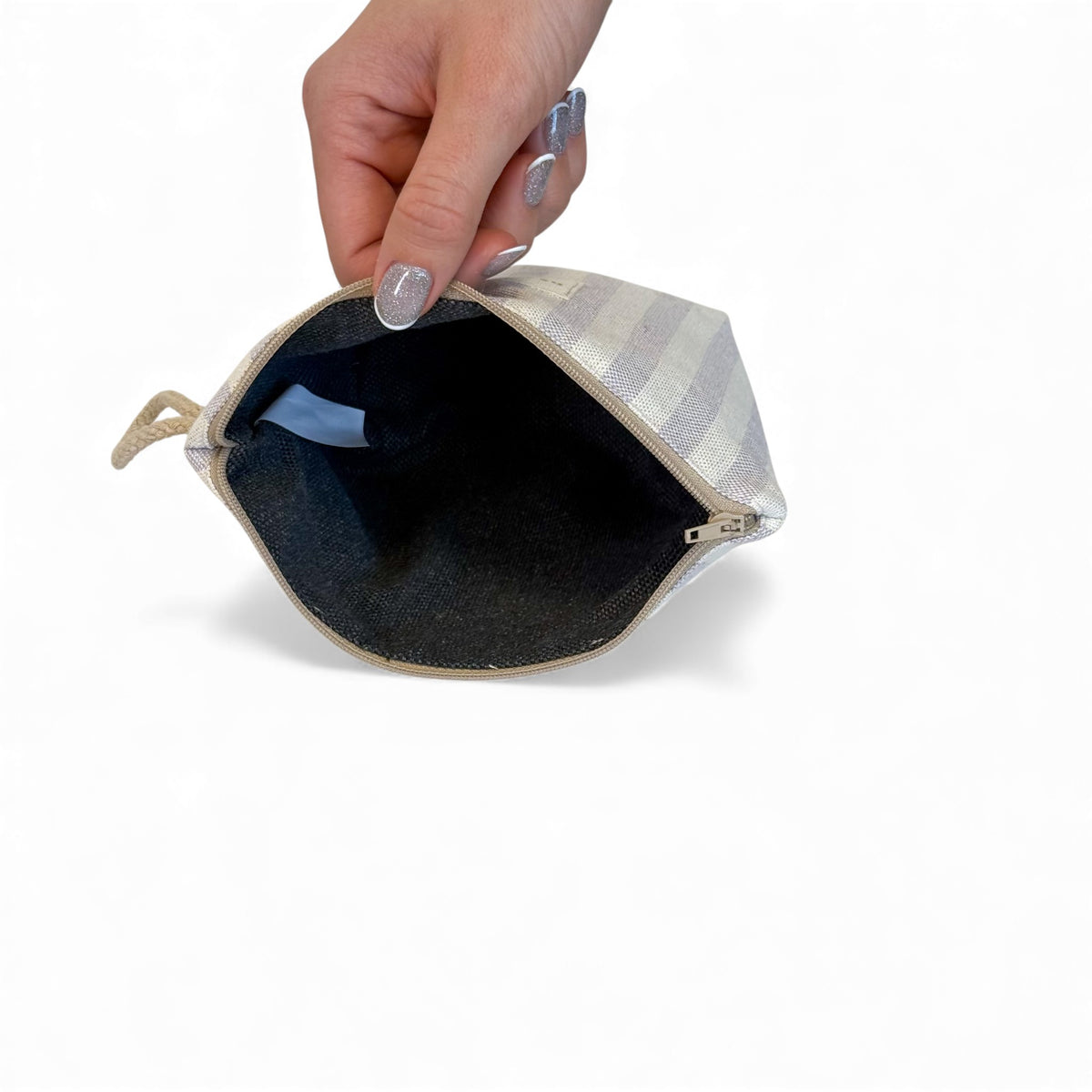 Open DE LA MUR Lulil makeup bag showing the dark lined interior