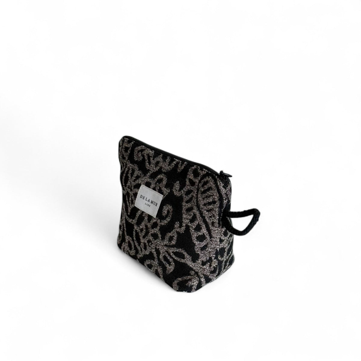 Three-quarter side view of the DE LA MUR Teide jacquard pouch with rope handle
