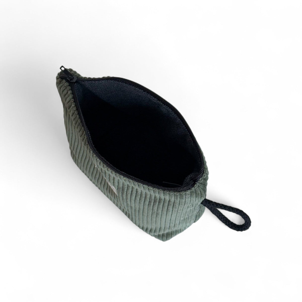 Open DE LA MUR Tree green corduroy makeup bag showing black interior lining