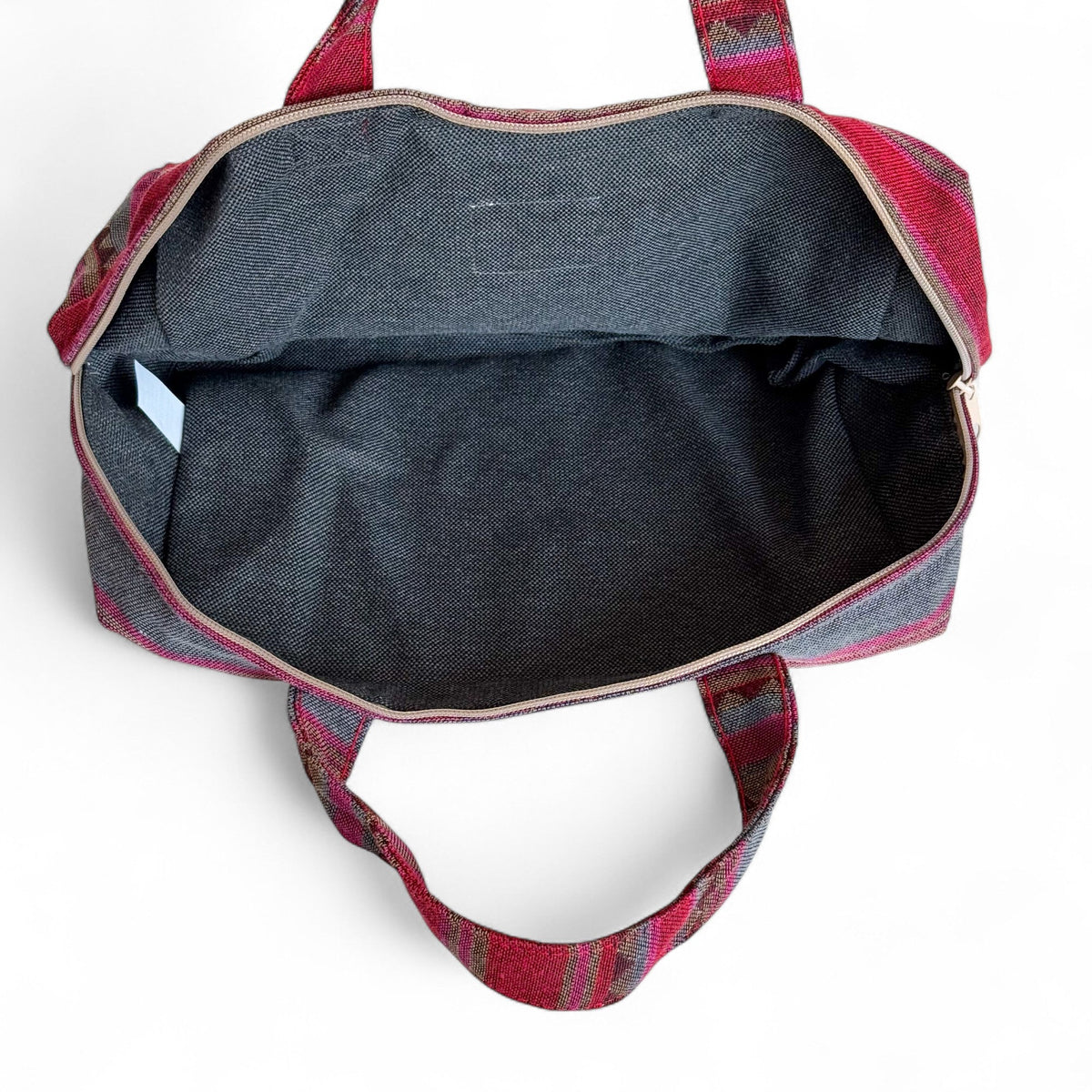 Open DE LA MUR Aura XL makeup bag showing the dark lined interior