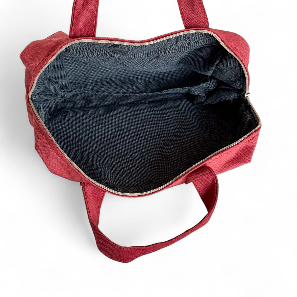 Open DE LA MUR Bore burgundy XL makeup bag showing the dark lined interior