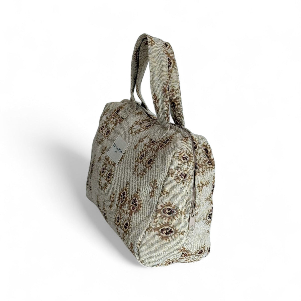 DE LA MUR Pluma XL makeup bag, side view showing zip closure and woven pattern