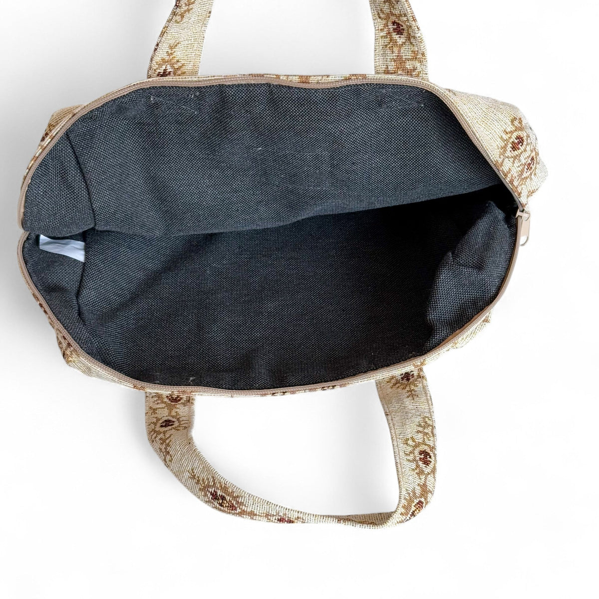 Open DE LA MUR Pluma XL makeup bag showing the black lined interior