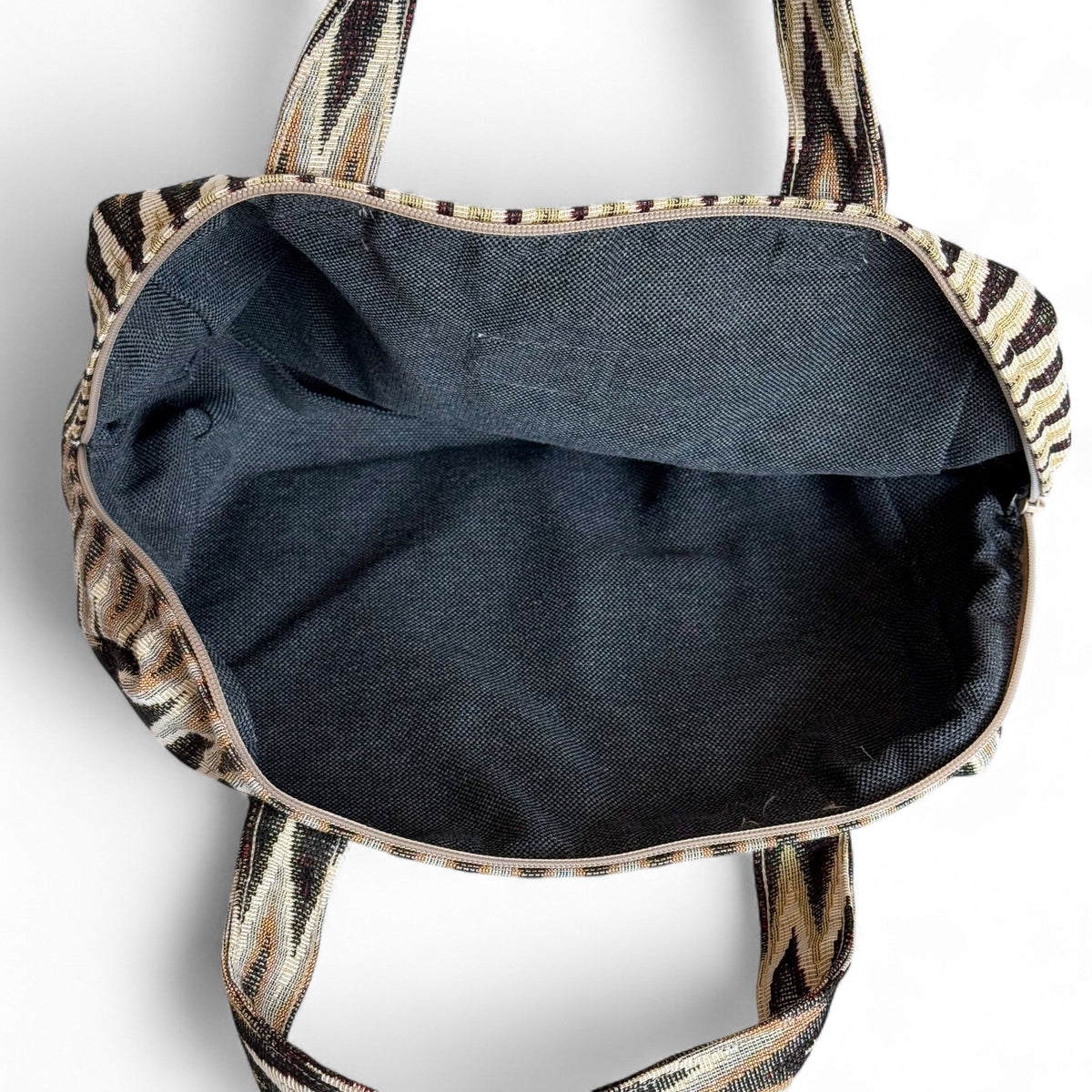 Open DE LA MUR Skan zigzag XL makeup bag showing the black lined interior