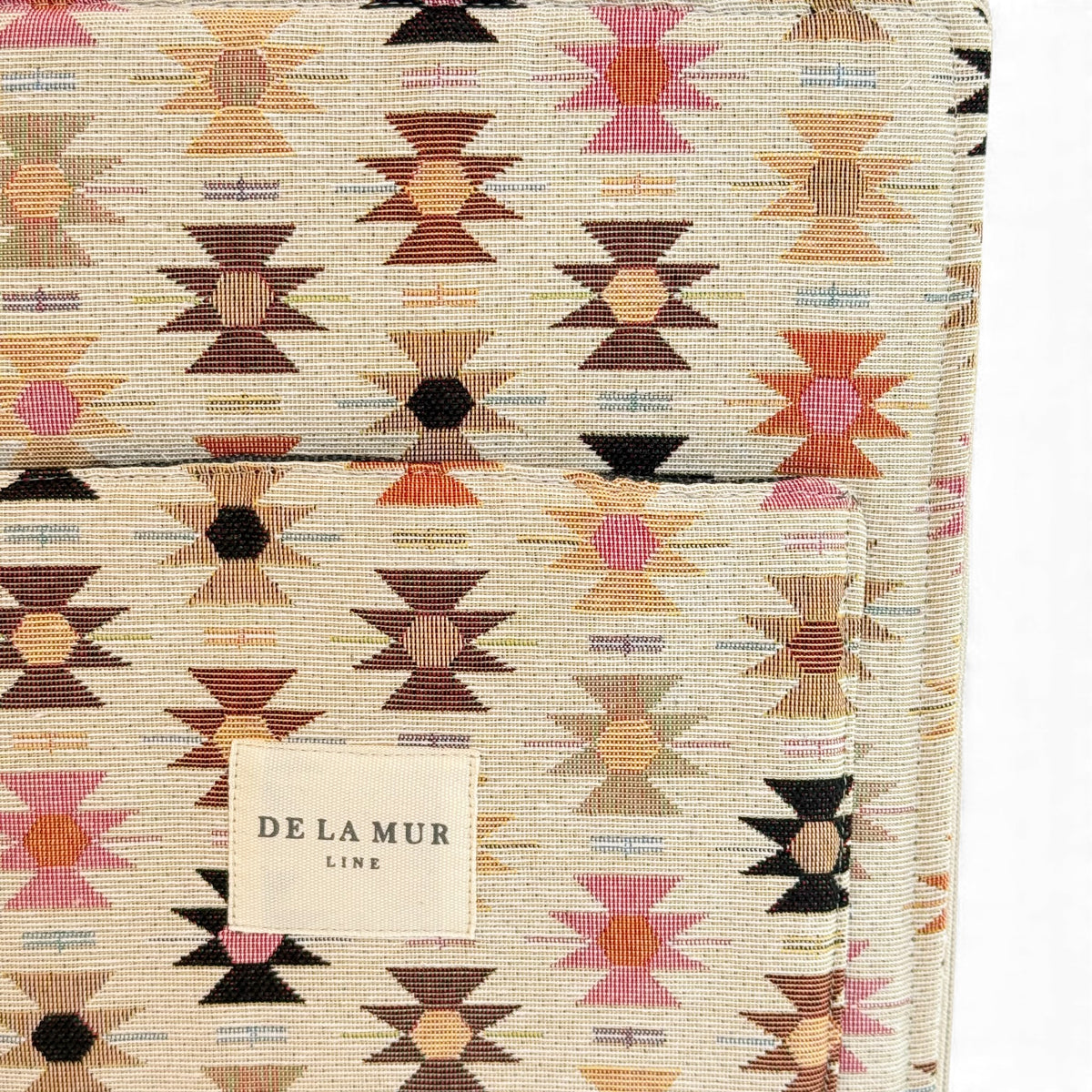 Detail of DE LA MUR Line label on the Royal geometric jacquard laptop bag