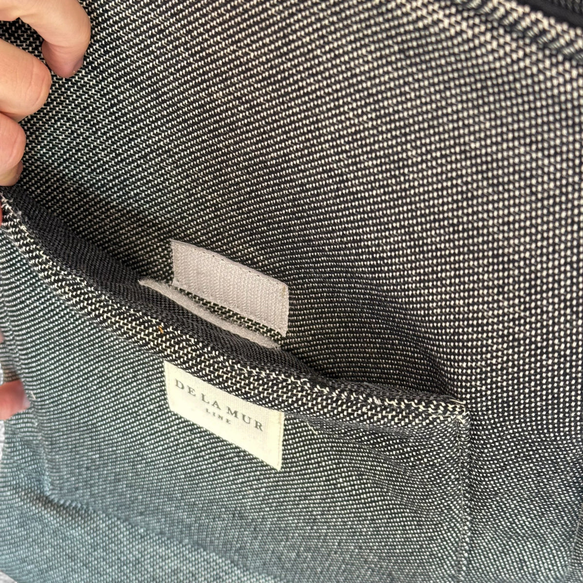 Close-up of the velcro exterior pocket inside the DE LA MUR Sinay laptop bag
