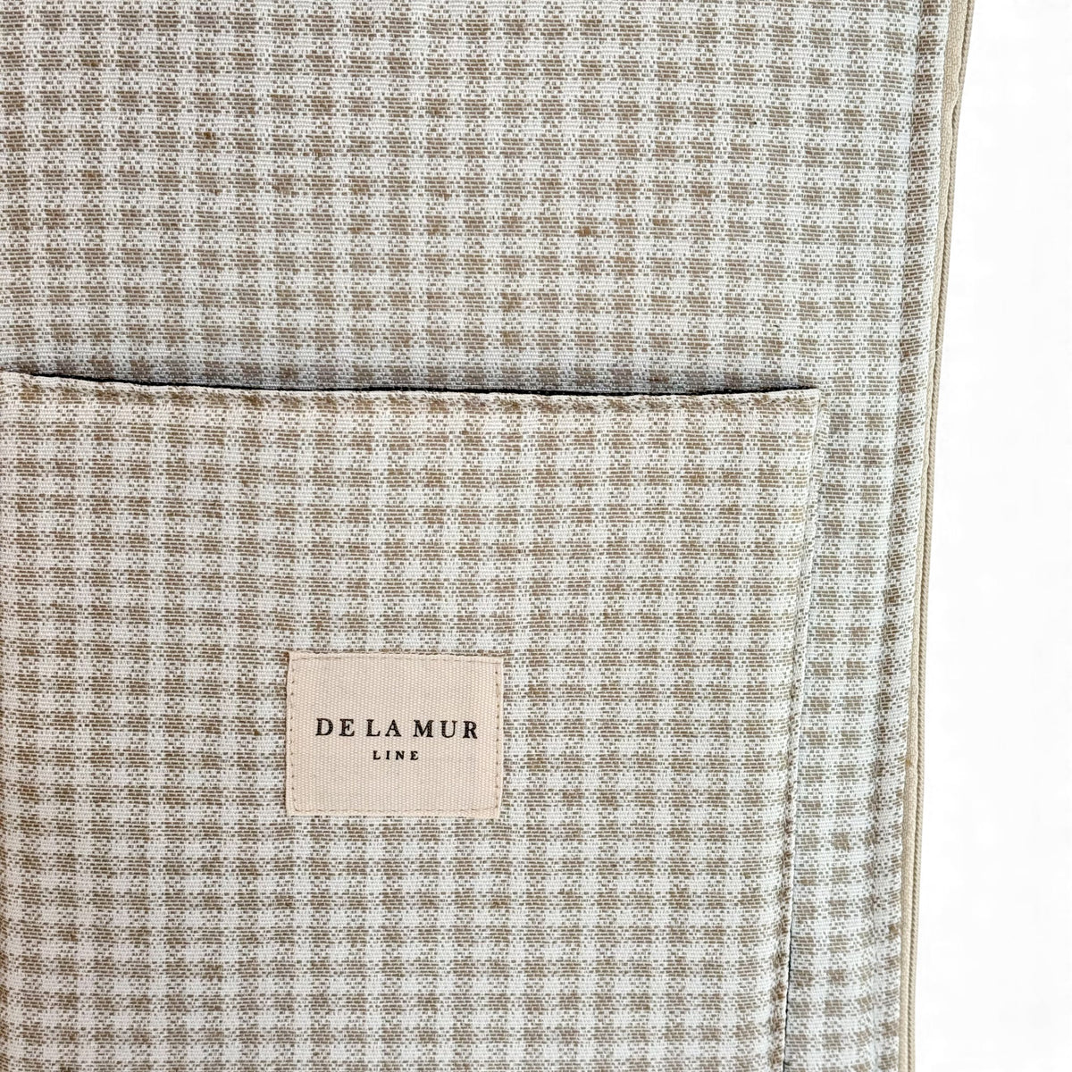 Detail of DE LA MUR Line label on the Vison beige check laptop bag