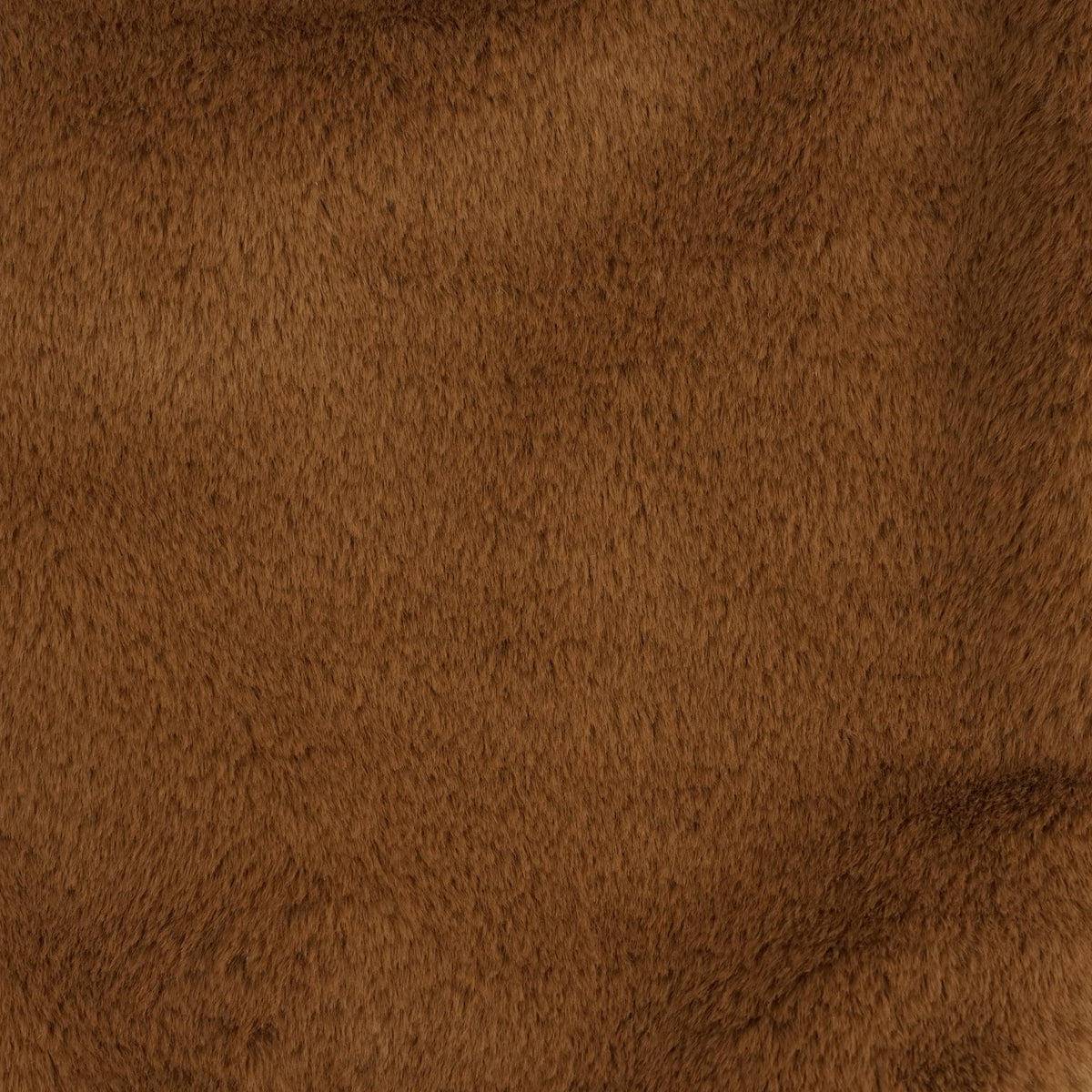Close-up of the soft faux fur texture of the DE LA MUR camel brown small handbag