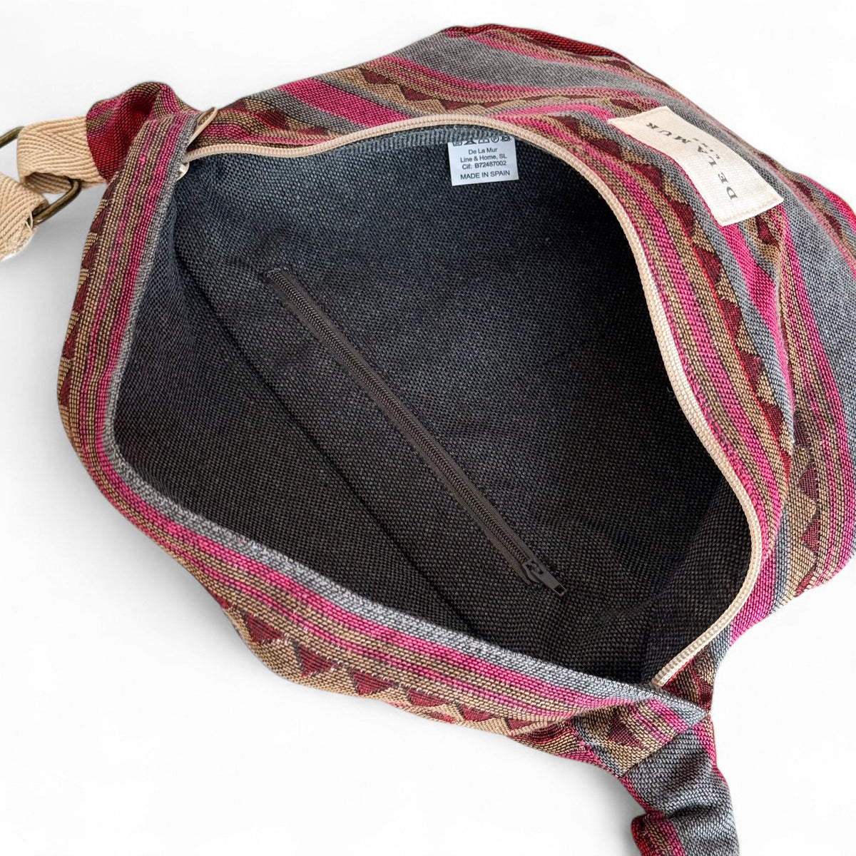Open DE LA MUR Aura fanny pack showing lined interior with zip pocket