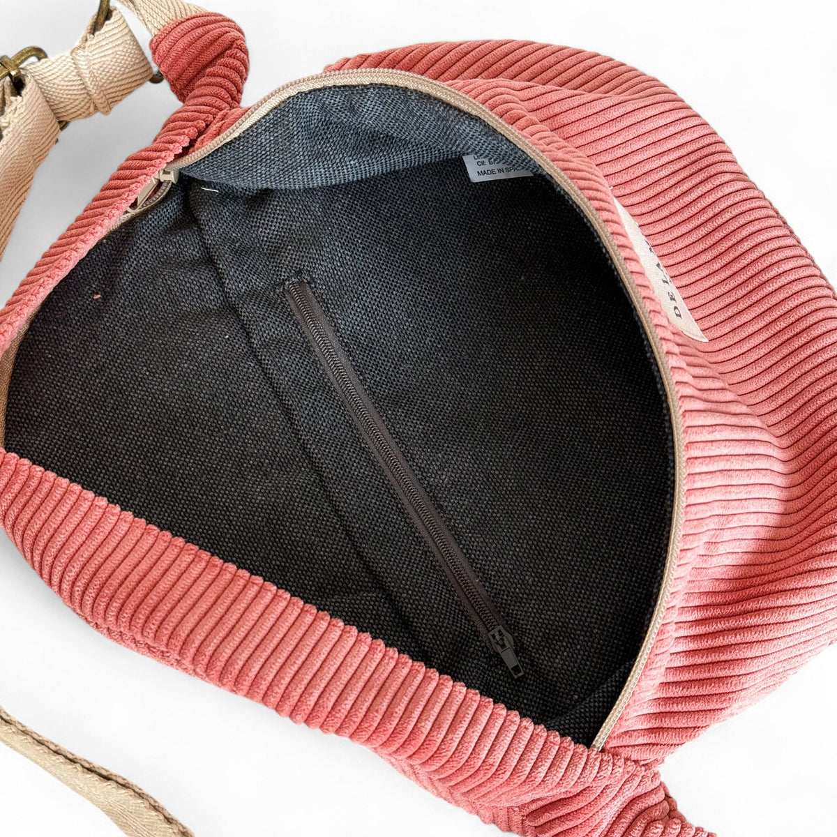 Open DE LA MUR Coral fanny pack showing lined interior with zip pocket