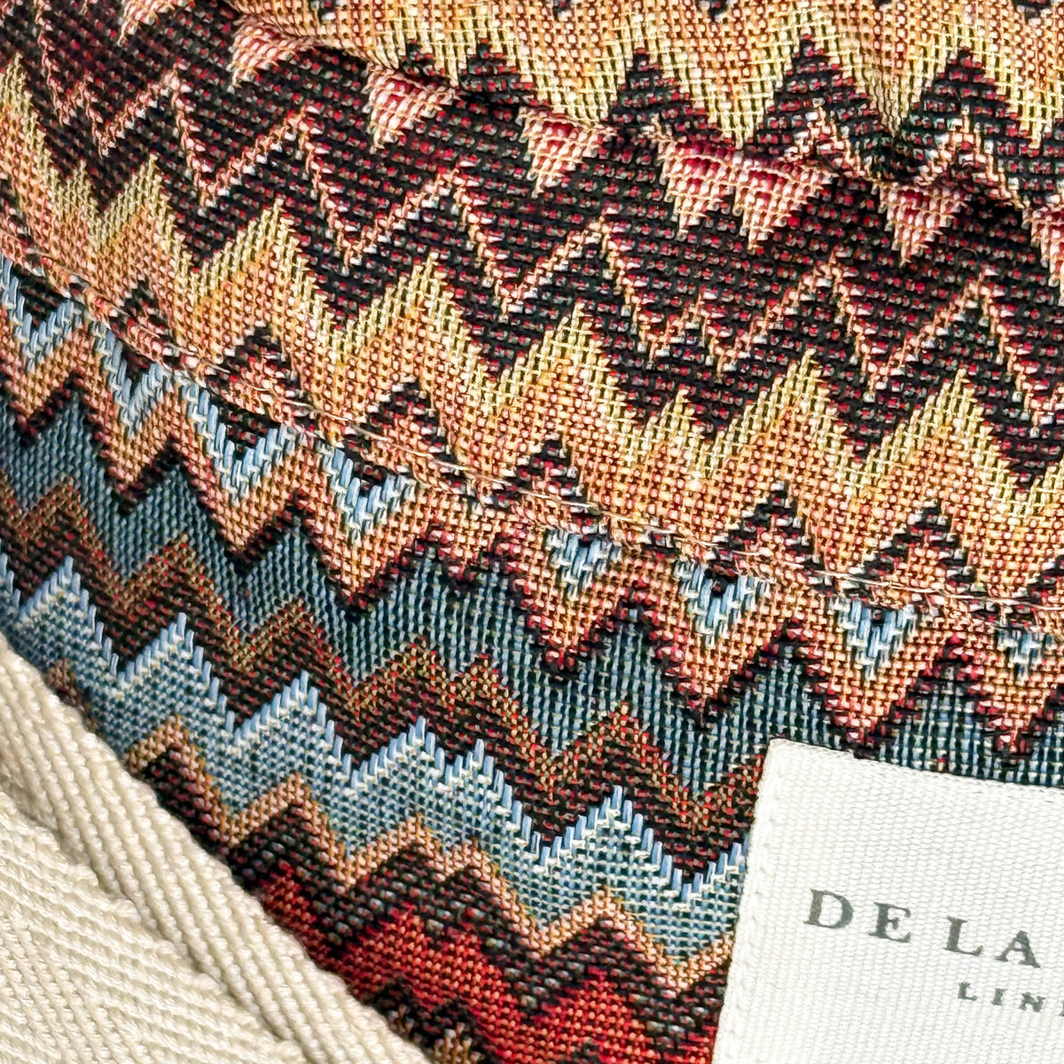 Close-up of the zigzag jacquard weave and DE LA MUR Line label on the Monte fanny pack