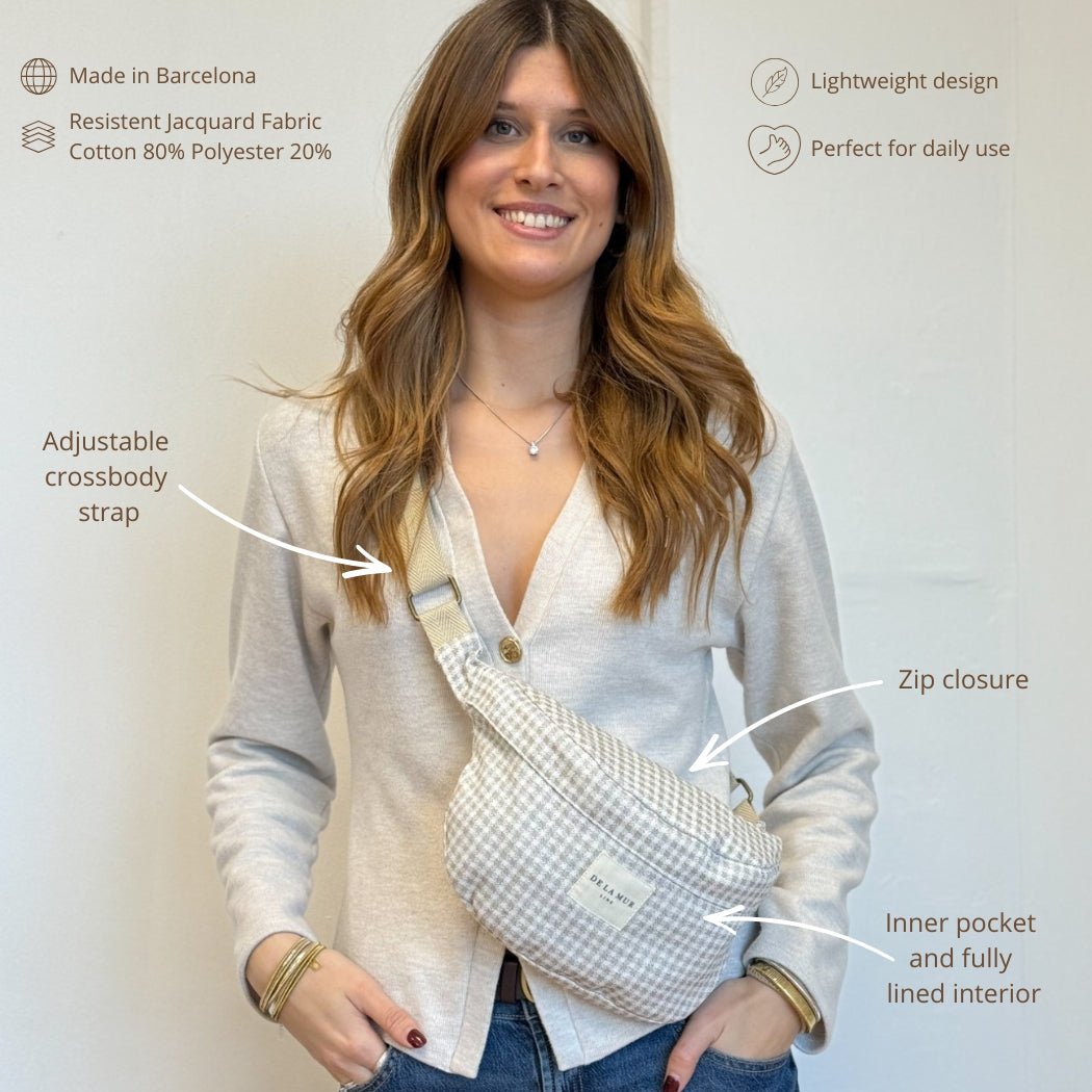 Model wearing DE LA MUR check Vison fanny pack crossbody with feature callouts