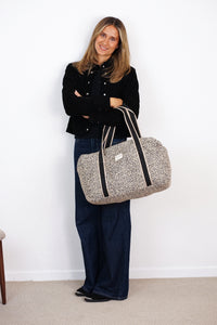 Model holding the DE LA MUR leopard jacquard Sports Bag (Koto), lifestyle shot