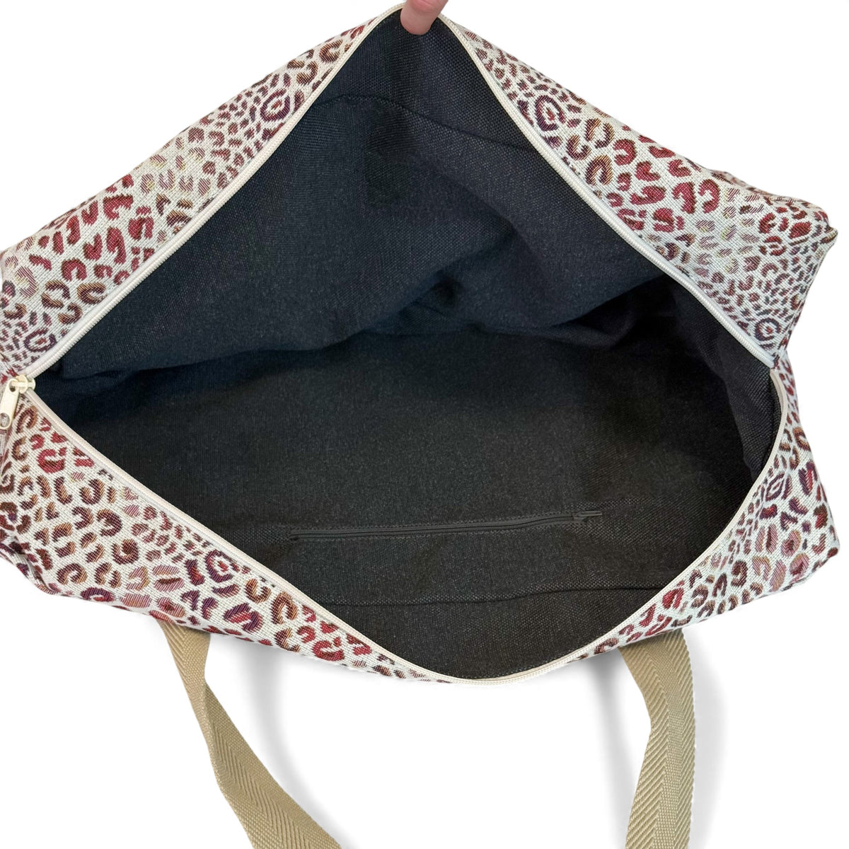 Open DE LA MUR leopard sports bag showing lined interior with inner zip pocket
