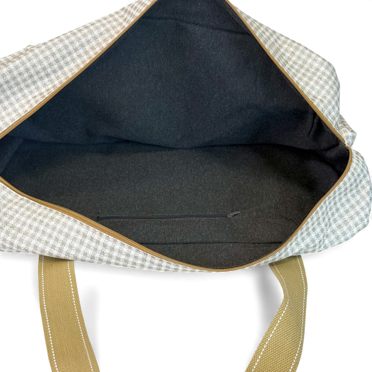 Open DE LA MUR gingham sports bag showing lined interior with inner pocket