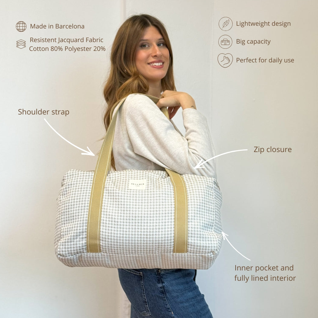 Model carrying DE LA MUR gingham jacquard sports bag with features infographic