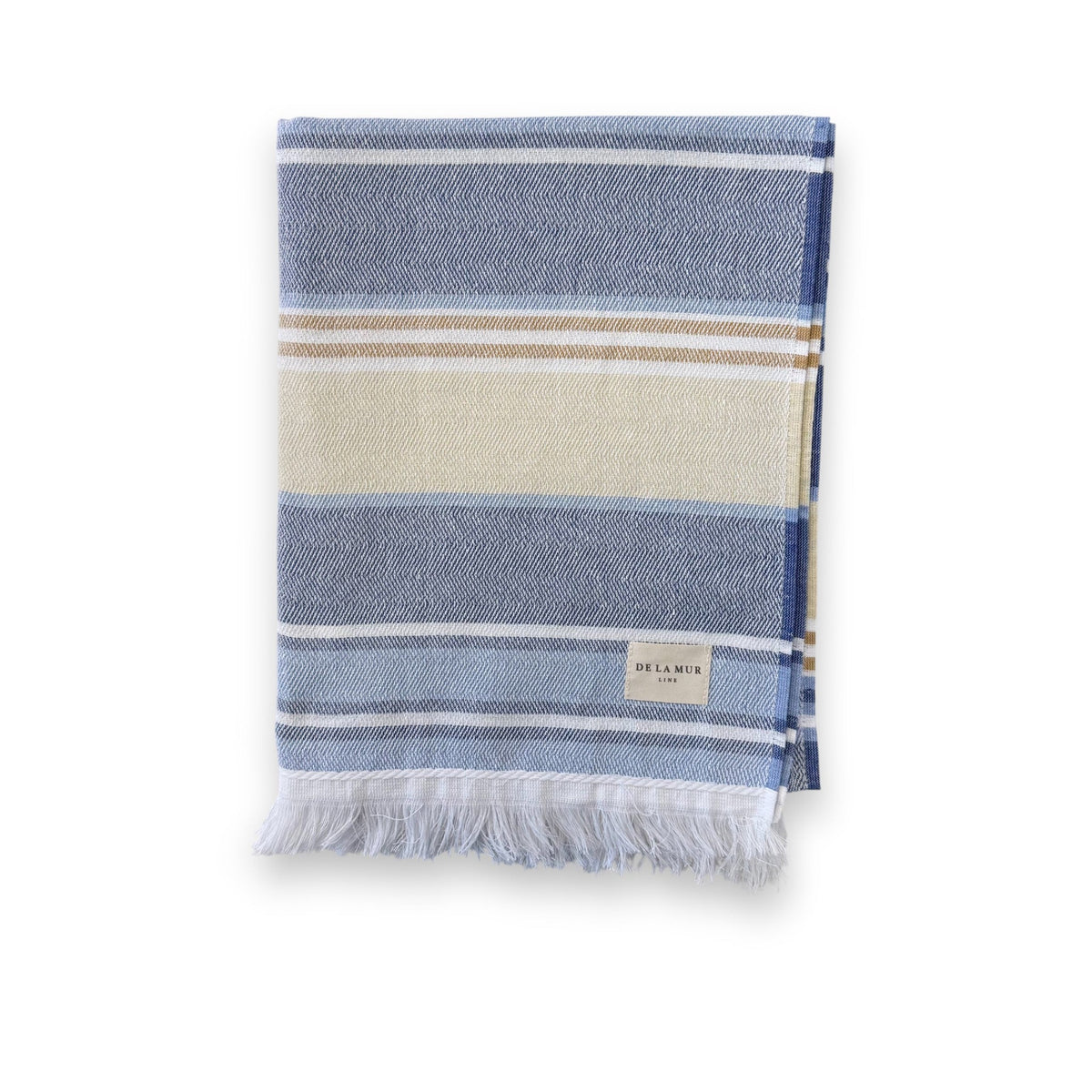 DE LA MUR striped towel in blue and cream, folded with fringed edge, front view