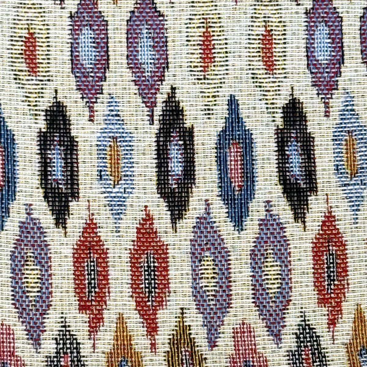 Close-up of the multicolor geometric jacquard fabric of the DE LA MUR Urban clutch