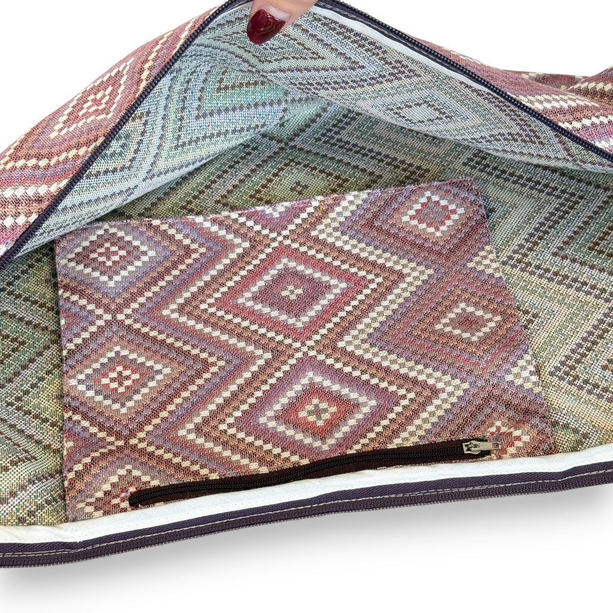 Open DE LA MUR Nana yoga mat bag showing lined interior and inner zip pocket