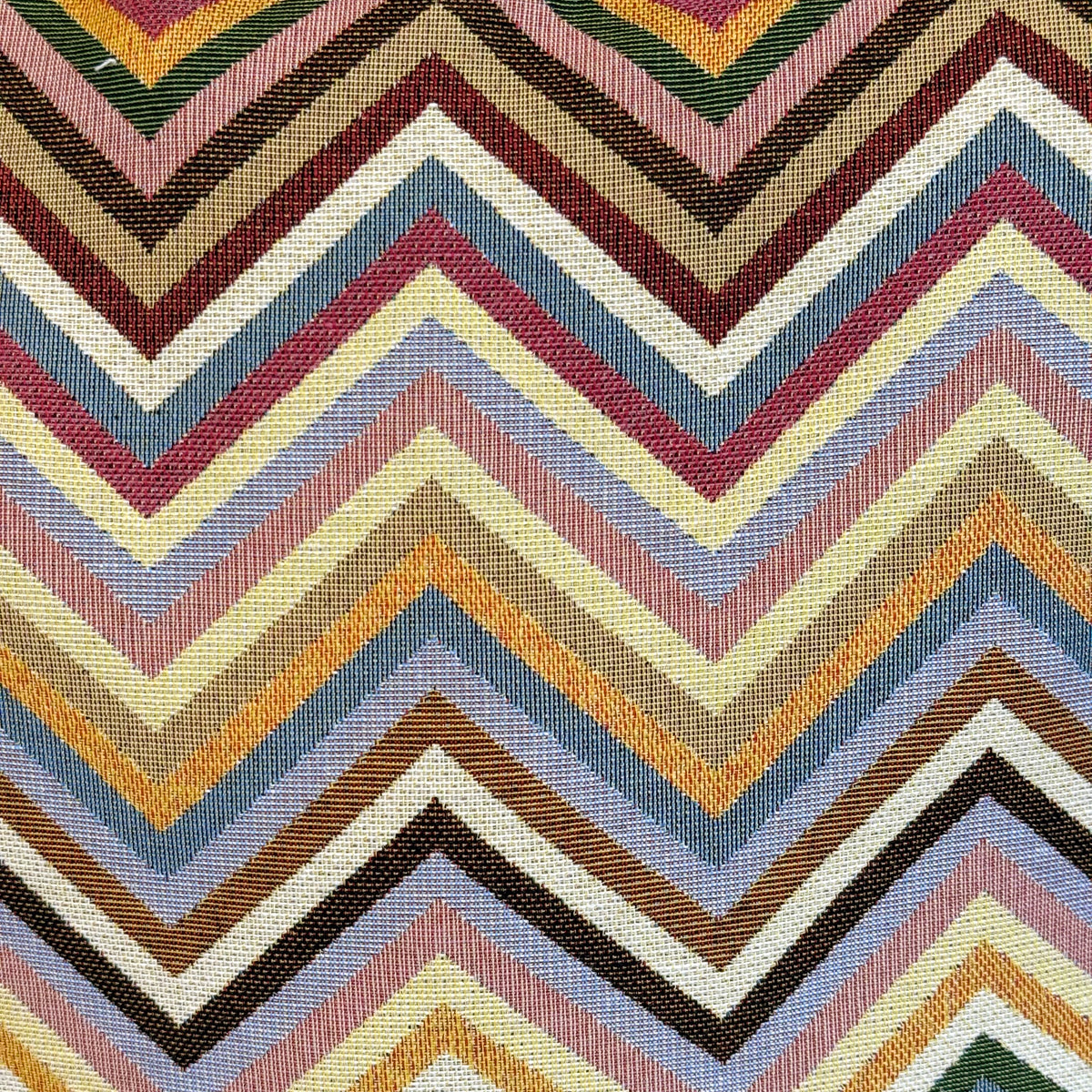 Close-up of the multicolor chevron jacquard fabric on the DE LA MUR makeup bag