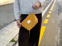 Model carrying the DE LA MUR Taz mustard corduroy pouch outdoors