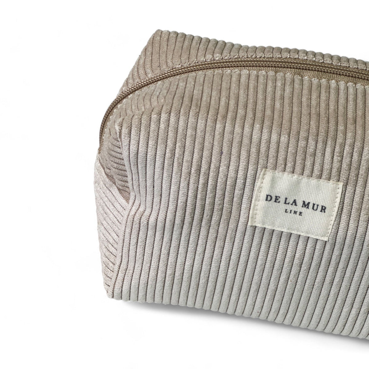 Close-up of the ribbed corduroy fabric and DE LA MUR Line label