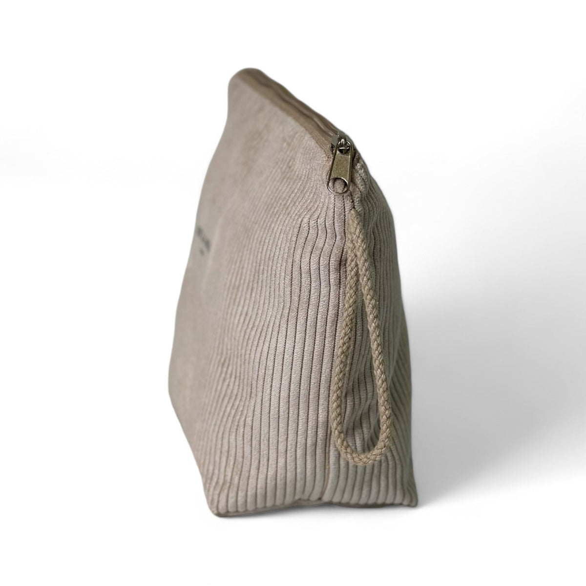 DE LA MUR Tofe beige corduroy makeup bag, side view showing zip pull and wrist strap